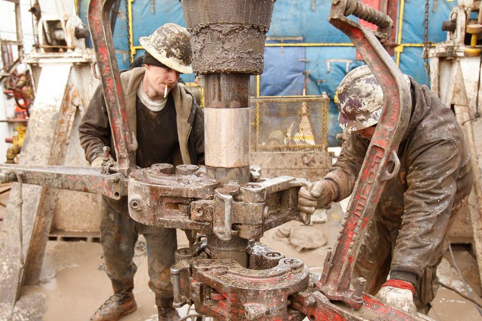Rig workers drill a saltwater well to draw fluids for hydraulic fracturing, or fracking, in Anthony, Kan., in February 2012.