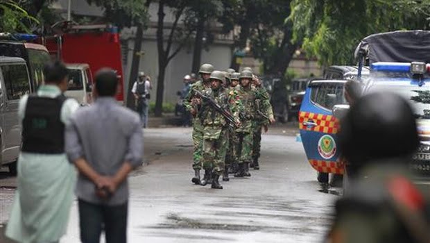 Bangladeshi soldiers come out of an area housing a restaurant popular with foreigners after heavily armed militants attacked it on Friday night and took dozens of hostages, in a diplomatic zone of the Bangladeshi capital Dhaka. (AP)
